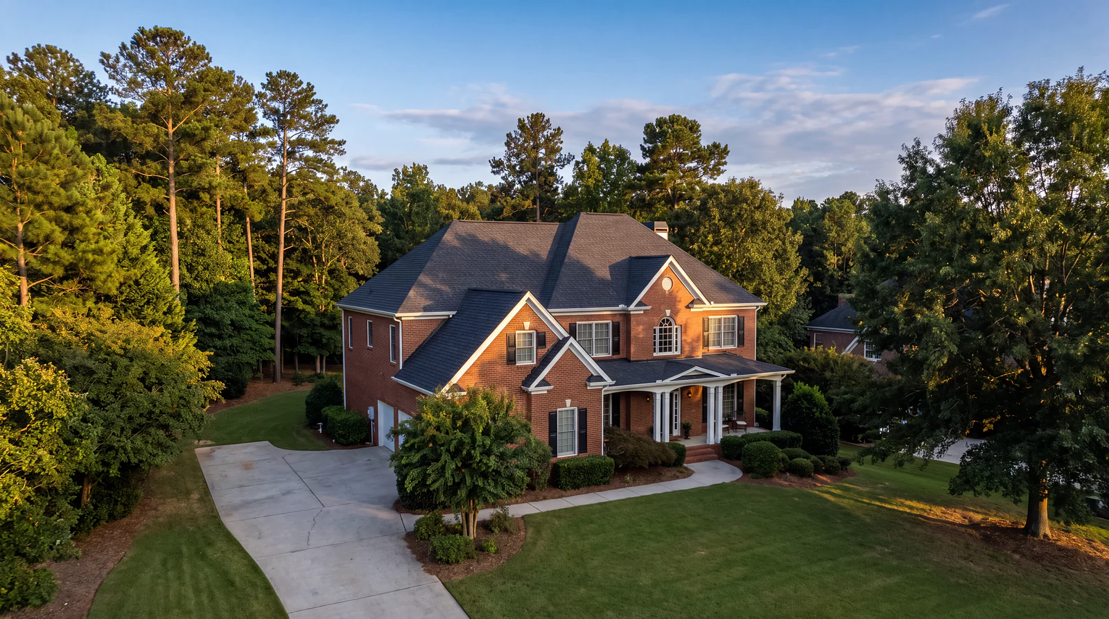 Aerial view of a two story brick home in North Georgia with a newly installed architectural shingle roof