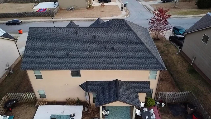 Two story stucco home in a North Georgia neighborhood after a complete roof replacement